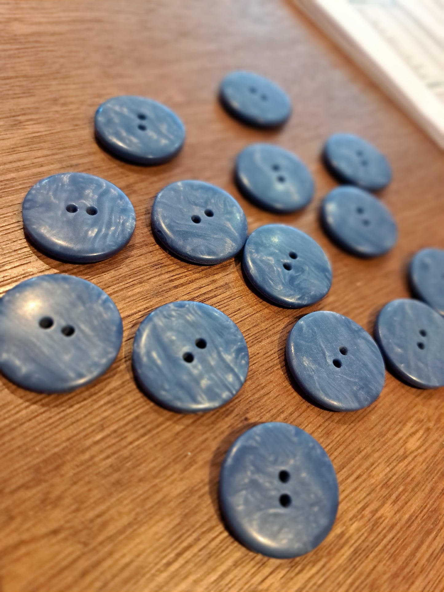 The buttons on a wooden surface.