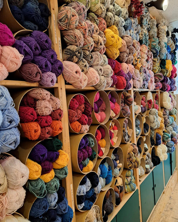 A long shot of circular shelves of wool looking full, colourful and neat.