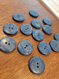 The buttons on a wooden surface. 